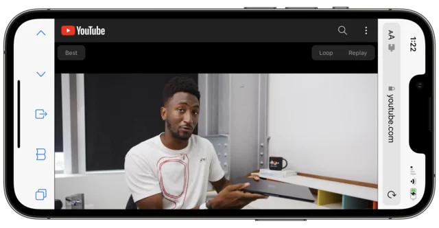An iPhone held upright with a YouTube page rotated sideways to fill the screen in landscape.